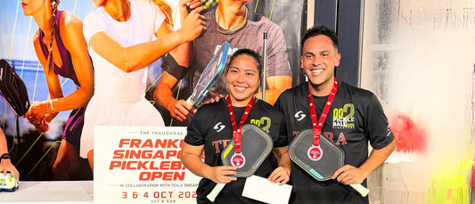 Roman and his mixed doubles partner with silver medals
