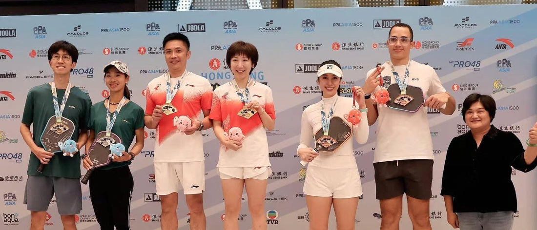 Regine Hoe, with her partner on the third step of the podium at the PPA Hong Kong Slam 2026.