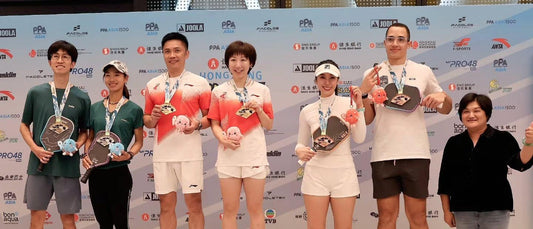 Regine Hoe, with her partner on the third step of the podium at the PPA Hong Kong Slam 2026.
