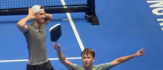 Federico Staksrud and Hayden Patriquin celebrate the title on court.
