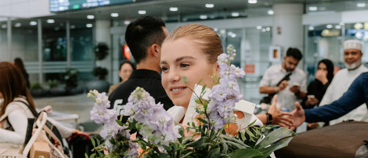 Anna Leigh Waters arriving at international arrivals in Malaysia with flowers