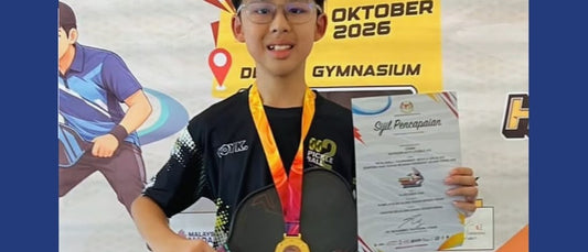 Koay Janson, 12, with his Men's Doubles U15 champion's medal and certificate.