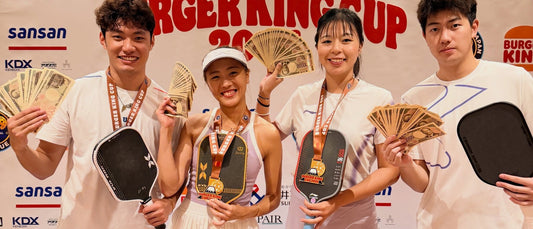 Agnes Fan's group, posing with medals and yen notes in front of the Pickleball Japan League Burger King Cup 2026 backdrop.