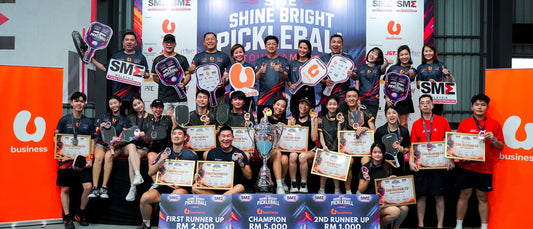 Medallists and organisers on the podium stage, with the trophy and the RM5,000, RM2,000 and RM1,000 prize boards.