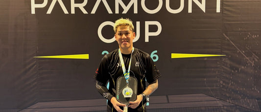 A player on the podium beside the First Runner Up placard, from Shaun Pickering's post.