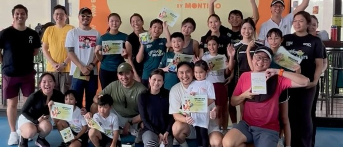 Little Picklers graduates and coaches holding certificates in front of an OiYO by Montigo banner