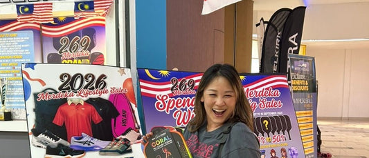 A winning MyPickleball customer poses with a Coral all-court paddle in front of the Merdeka sale posters at the Strand Mall outlet.